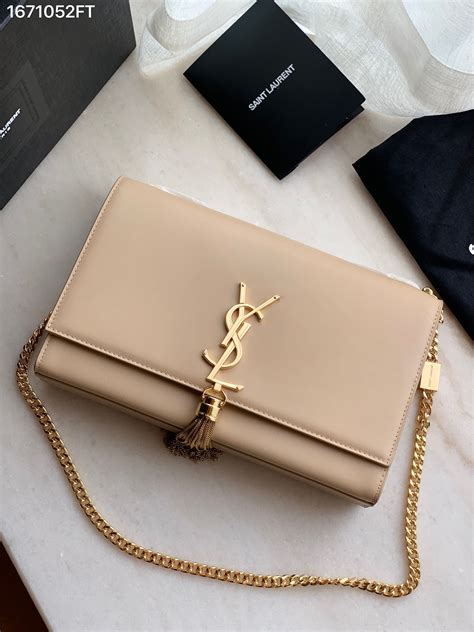 ysl beige bag with tassel.